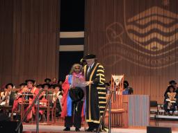 Ms Ellis on stage with ANU Chancellor Professor the Hon Gareth Evans AC QC 